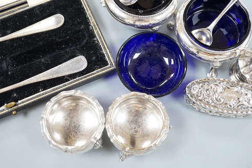 A pair of Victorian silver bun salts with blue glass liners and spoons, a spare liner, a later pair of small silver salts, a silver pepperette, a small silver box and a silver christening pair in box for three.